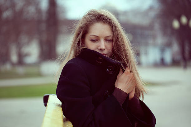 istock Young woman wrapped in a coat from the cold 178439736
