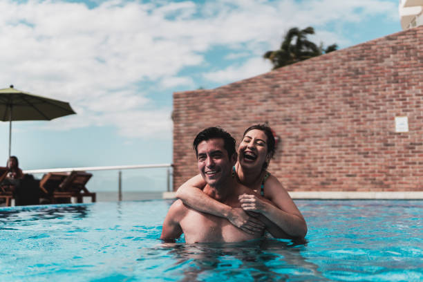 istock Happy couple in the pool at hotel 1784398890