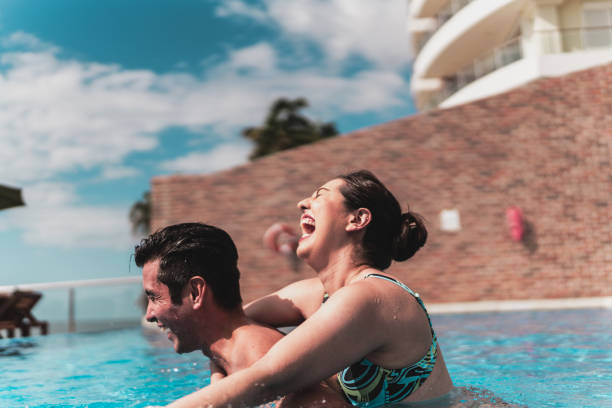 istock Friends playing in the pool at hotel 1784399041