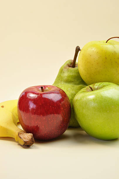 Healthy food group - fruit: apples,, pear and banana - for healthy living diet, and good nutrition - vertical with copy space.