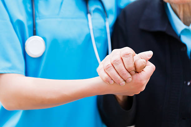 istock Nurse in blue uniform holding elderly lady's hand 178440527