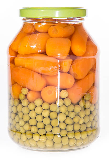 Carrots and Peas in a glass isolated on white background