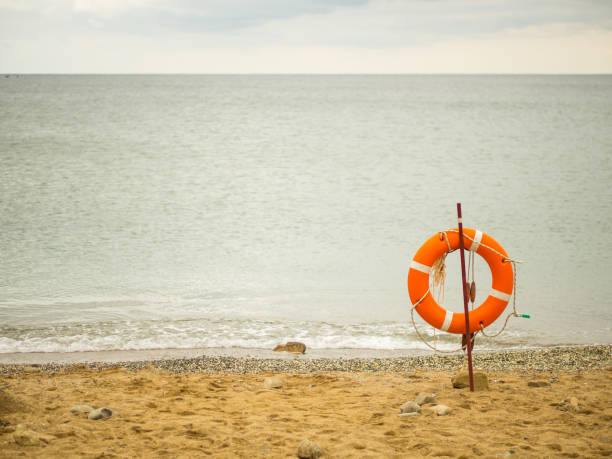 life orange ring on the beach overlooking the sea. copy space