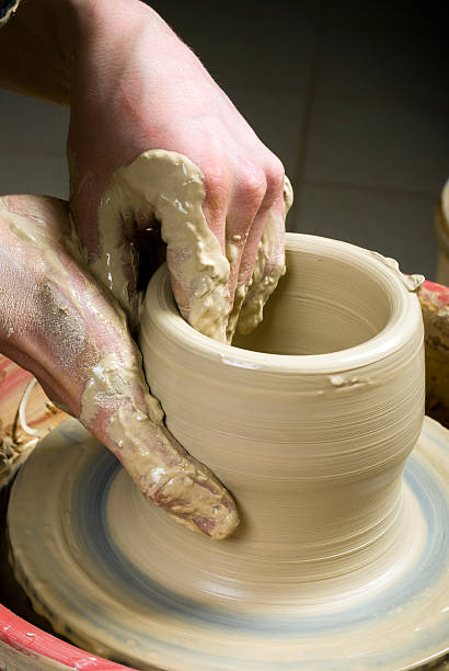 istock hands of a potter, creating an earthen jar 178442755
