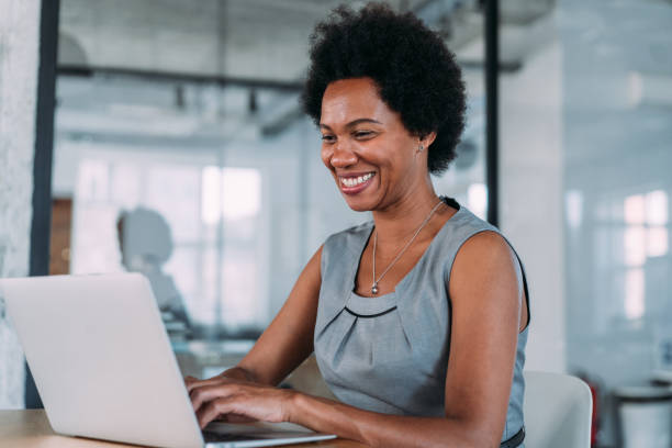 istock Successful businesswoman in modern office working on laptop. 1784432104