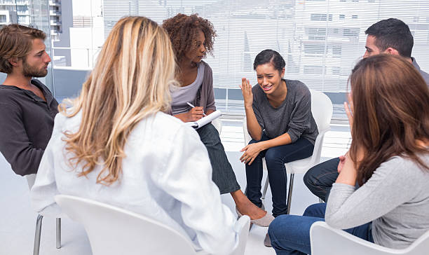 istock Woman getting depressed in group therapy 178443293