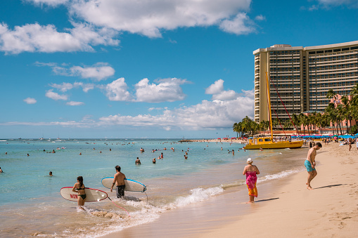 Honolulu, Oahu, HI, US-October 29, 2023: People swimming on the famous Waikiki Beach.