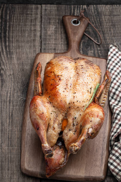 istock Baked duck stuffed with apples on wooden board 1784437096