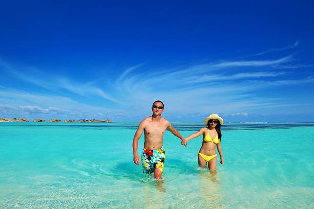 istock happy young  couple enjoying summer on beach 178443973