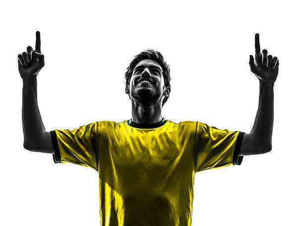one brazilian soccer football player young man happiness joy pointing up  in silhouette studio on white background