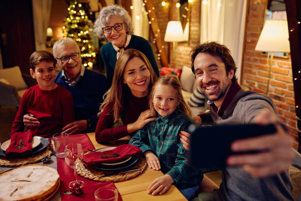 istock Happy extended family taking selfie while celebrating Christmas together. 1784444631