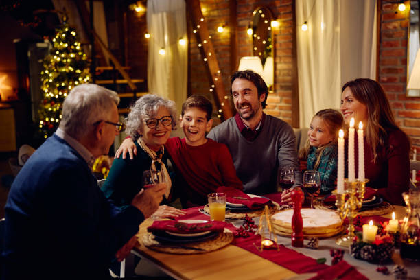 istock Joyful extended family talking at dining table on Christmas eve. 1784445718
