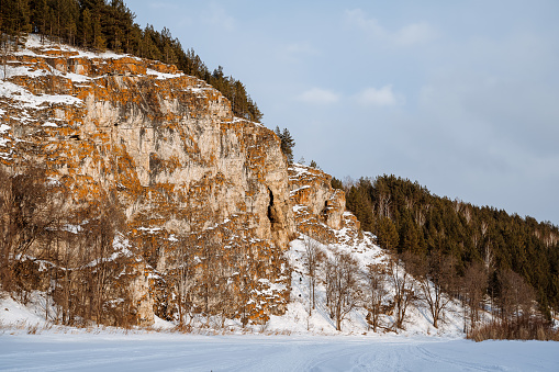 Ust Katavskaya Cave on the Katav River, Southern Ural Russia. Maryin Rock cliff in winter. Hapov ridge in the snow.