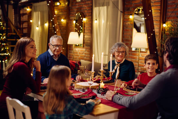 istock Happy multigeneration family talking during Christmas dinner at dining table. 1784447940