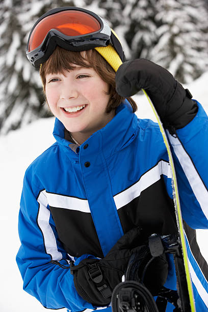 istock Young Boy With Snowboard On Ski Holiday In Mountains 178445632