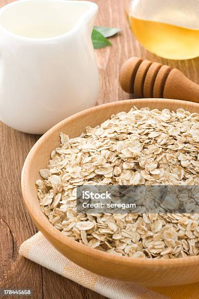 Bowl Of Oat And Milk On Wood Stock Photo - Download Image Now - Bowl, Brown, Cereal Plant