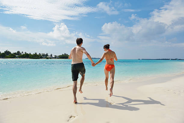 istock happy young couple have fun on beach 178446660