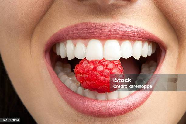 Perfect Teeth Biting Raspberry Stock Photo - Download Image Now - Raspberry, Adult, Beautiful People