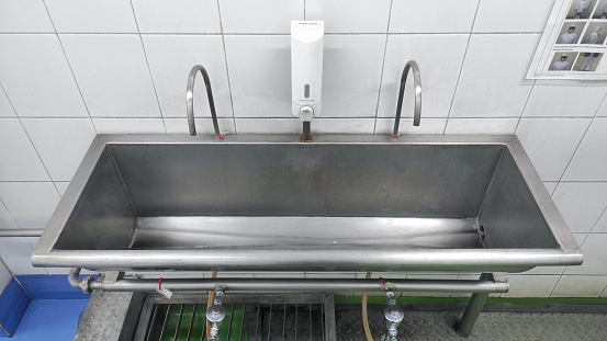 Stainless steel sink in the factory for workers to wash their hands before go to work