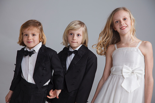 Siblings in evening dresses. Nice white dress and tux. Ready for the wedding.
