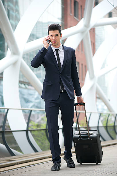 istock Businessman talking on phone and traveling with bag 178447576