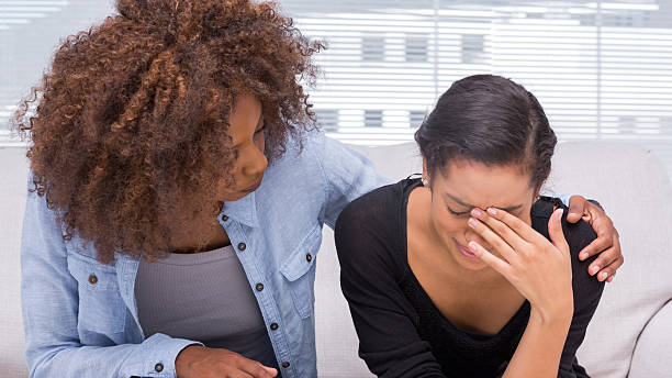 istock Sad woman crying next to her therapist 178447714