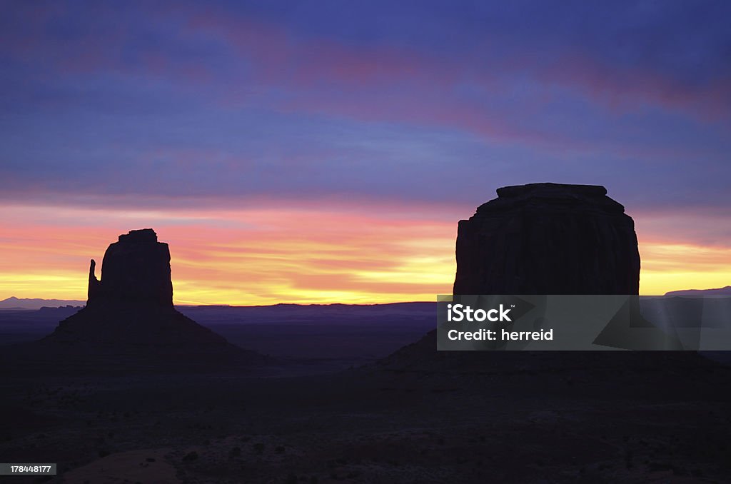 East Mitten and Merrick Buttes Sunrise, Monument Valley Beautiful Red East Mitten Butte Sunrise, Monument Valley (Navajo Permit on File) Arizona Stock Photo