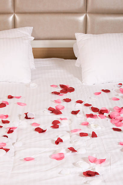 istock hotel room with big bed and red flowers 178448455