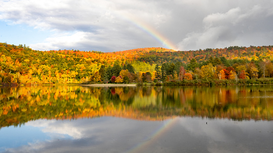 Fall foliage and a rainbow on Echo Lake in Plymouth, Vermont