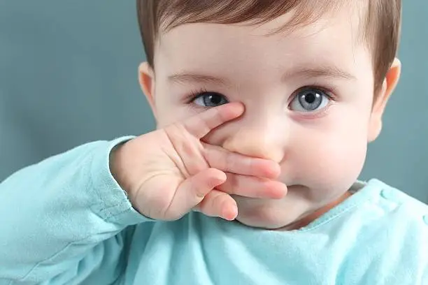 Photo of Close up of baby looking at camera with blue eyes