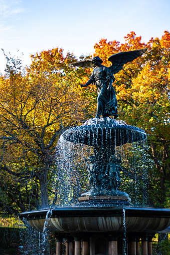 Angel of the Waters, a bronze sculpture atop Bethesda Fountain in Central Park, Manhattan, New York City in the fall