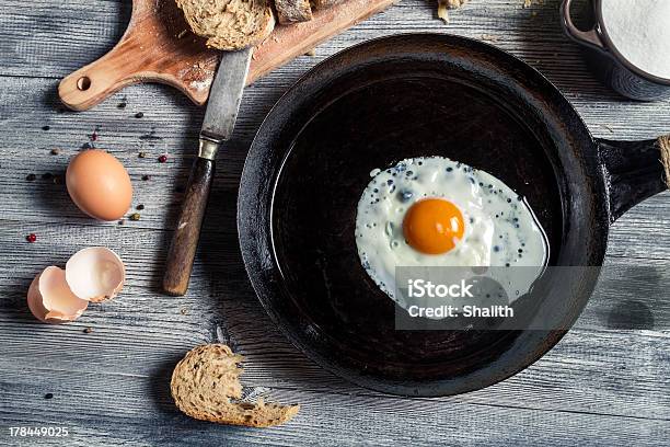 Closeup Of Fried Egg On A Cast Iron Pan Stock Photo - Download Image Now - Animal Egg, Bread, Breakfast