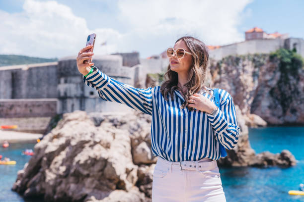 istock Beautiful young woman taking selfies 1784509367