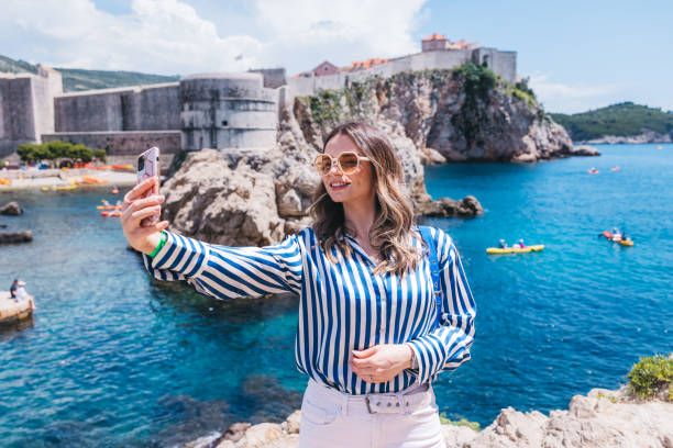 istock Beautiful young woman taking selfies 1784509372