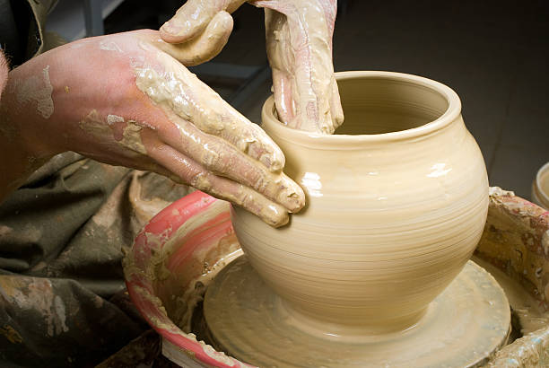 istock hands of a potter, creating an earthen jar 178450938