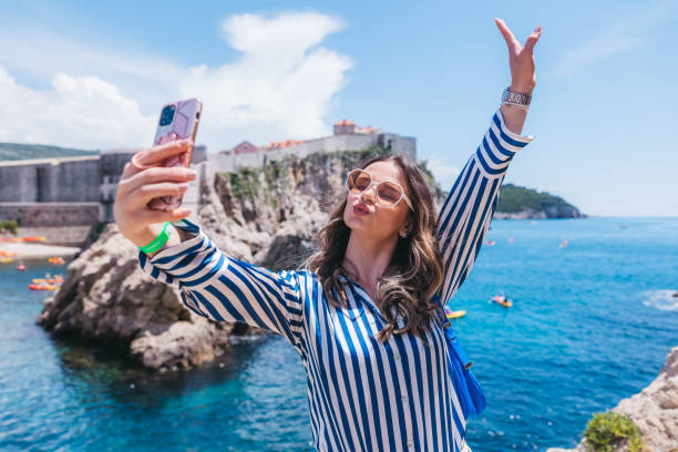 istock Beautiful young woman taking selfies 1784510435