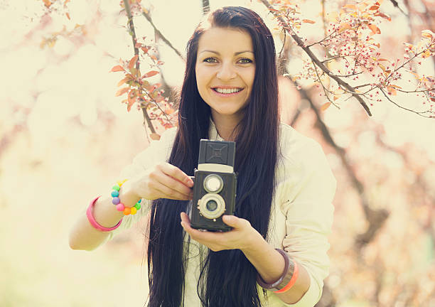 istock Beautiful girl with camera in spring park 178451132