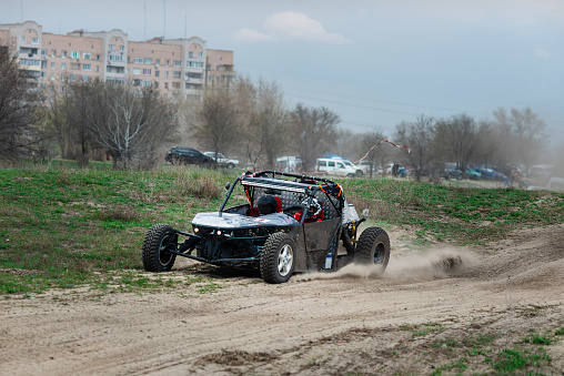 UTV buggy in the action on sand in summer