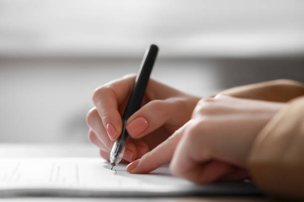 istock Woman signing documents at table in office, closeup. Space for text 1784519478