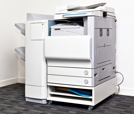 Big grey multi task copy machine in office corner