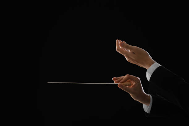 istock Professional conductor with baton on black background, closeup. Space for text 1784527661