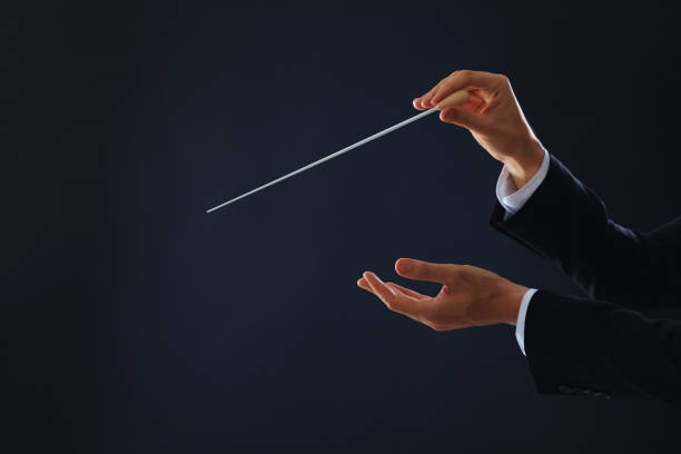 istock Professional conductor with baton on black background, closeup. Space for text 1784527665