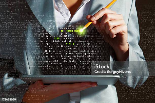 A Woman Holding A Tablet Pressing Random Strings Of Numbers Stock Photo - Download Image Now