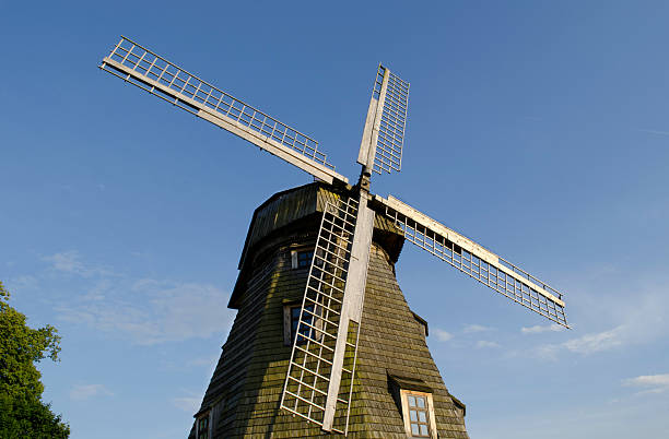 istock Retro wooden mill  wings against blue sky 178453112