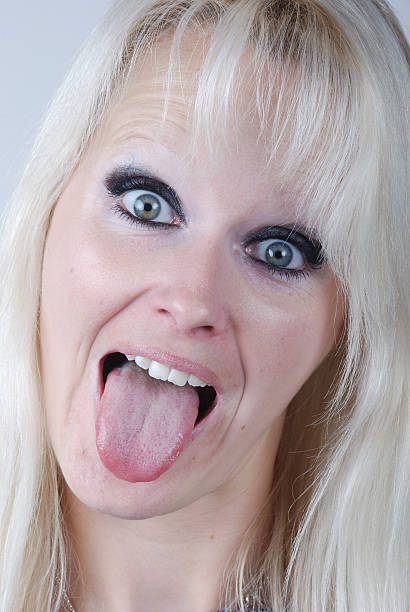 istock Young blond woman sticking out her tongue 178453650