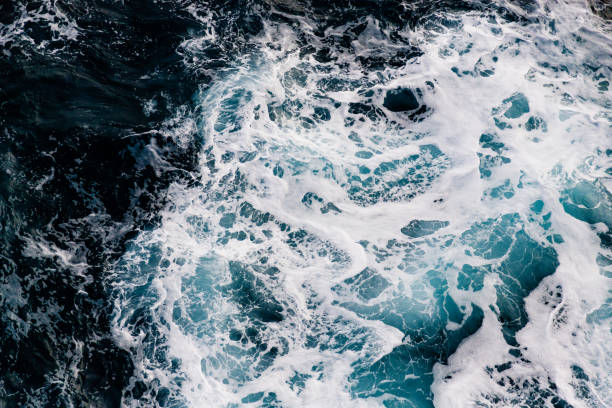 istock Blue turquoise sea water background with white foam waves 1784536655
