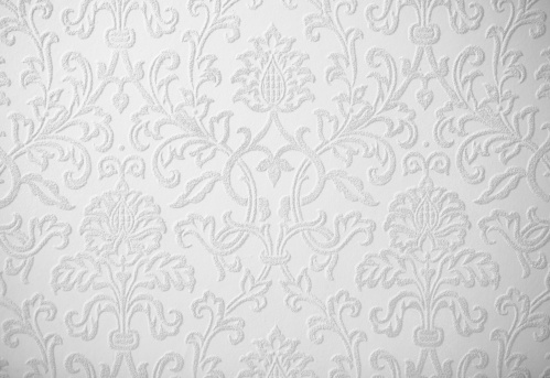 A horizontal background of gradient textured bright light grey and white backdrop, Smudges, grooves and faint stains, strokes or scratches all over with ample copy space, no people and no text. Can be used as wallpapers, textures templates and designs.