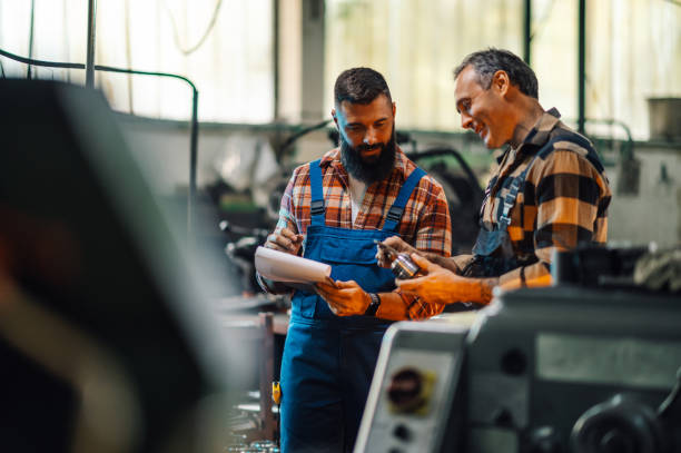 istock Two mechanics measuring a small metal part in a workshop, writing on clipboard. 1784540741