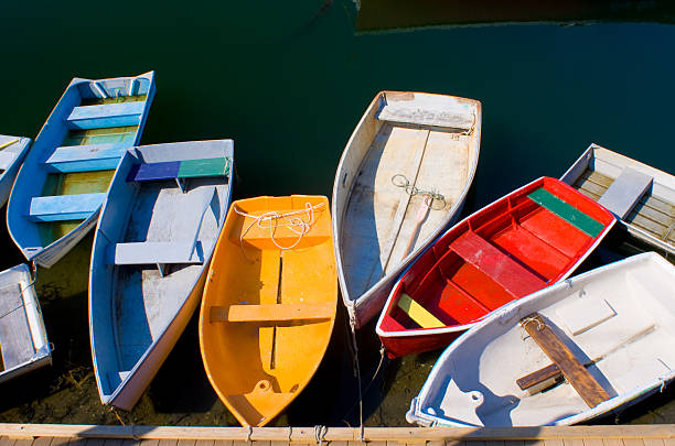 Colorful Dinghies Colorful dinghies tied up at a dock in Rockport, MA essex county massachusetts stock pictures, royalty-free photos & images