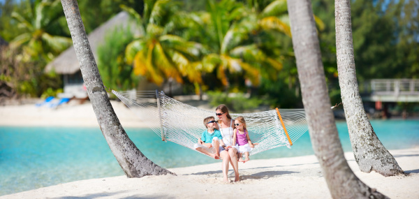 Mother and two kids relaxing on hammock at tropical beach, 12 photos panorama